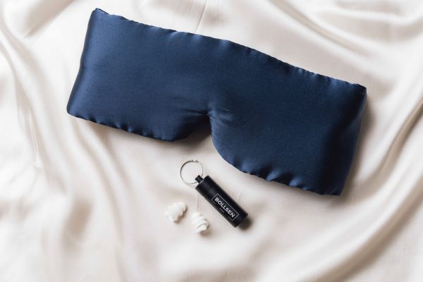 Mask and earplugs placed on a bed