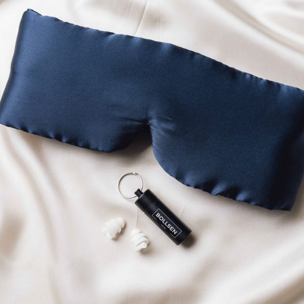 Mask and earplugs placed on a bed