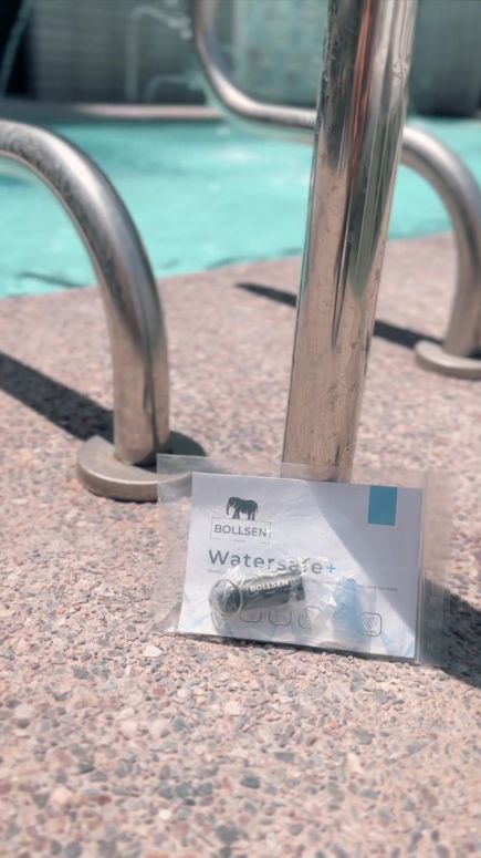Silver pool ladder beside a clear blue pool, with a transparent package labelled "Watersafe+".